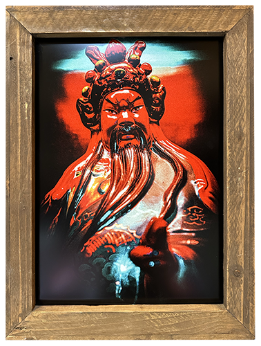 A framed metal print featuring a black and red depiction of the historical figure Duke Guan, with a wooden frame.