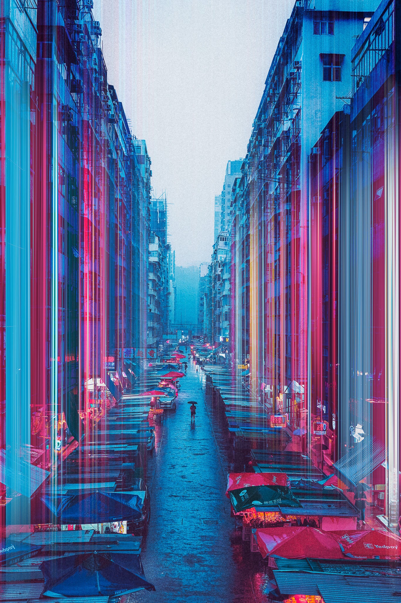 A colorful photograph of a city street filled with cars and buildings, showing a blend of red, blue, and purple hues.