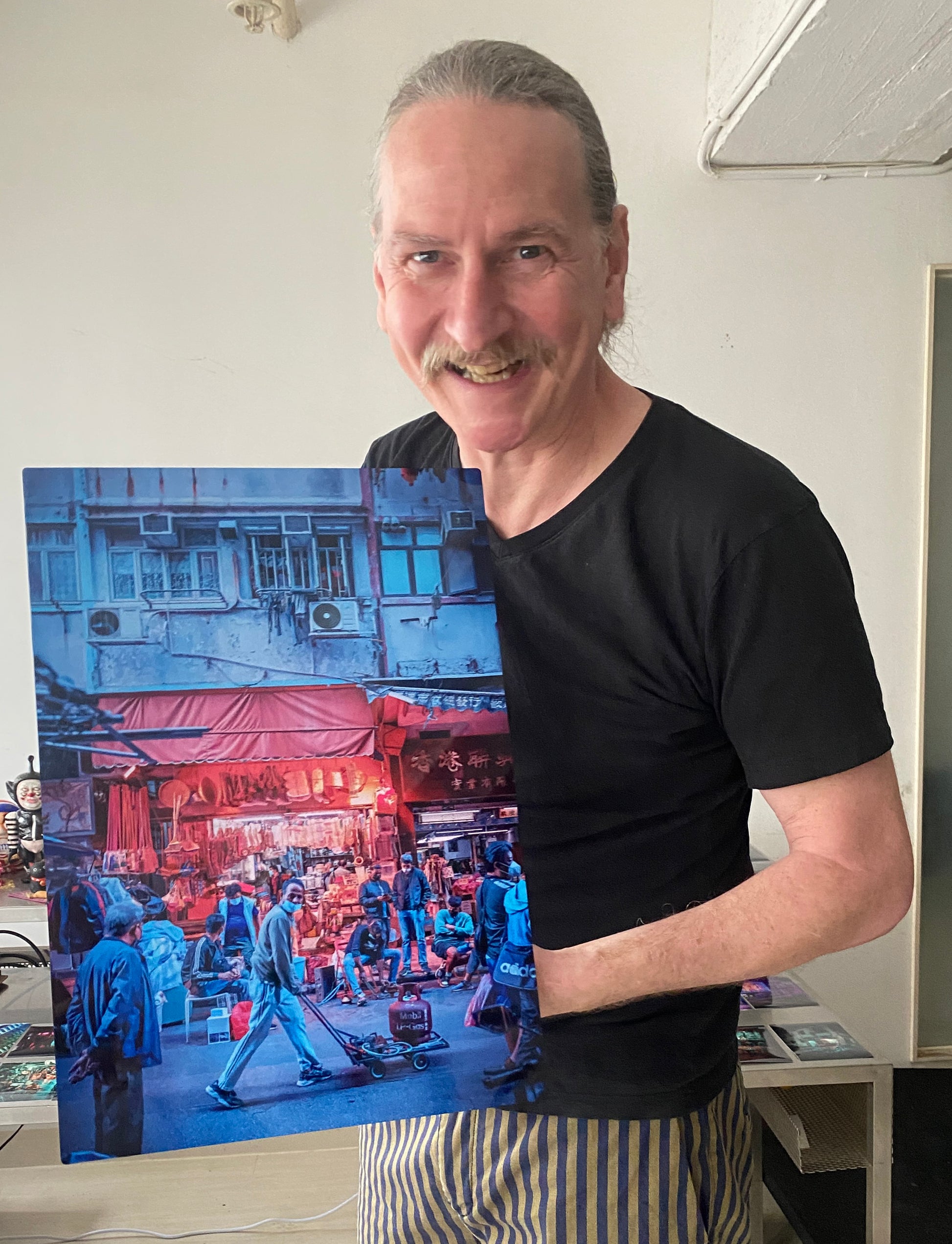 Chromoluxe metal print being held by the artist Dickie Suzuki