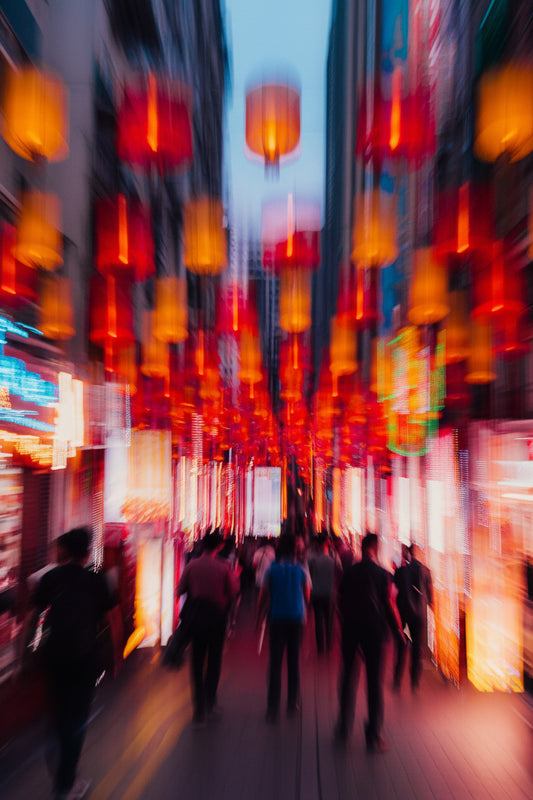 Abstract image of a city street at night with neon lights creating a blurred, vibrant pattern.