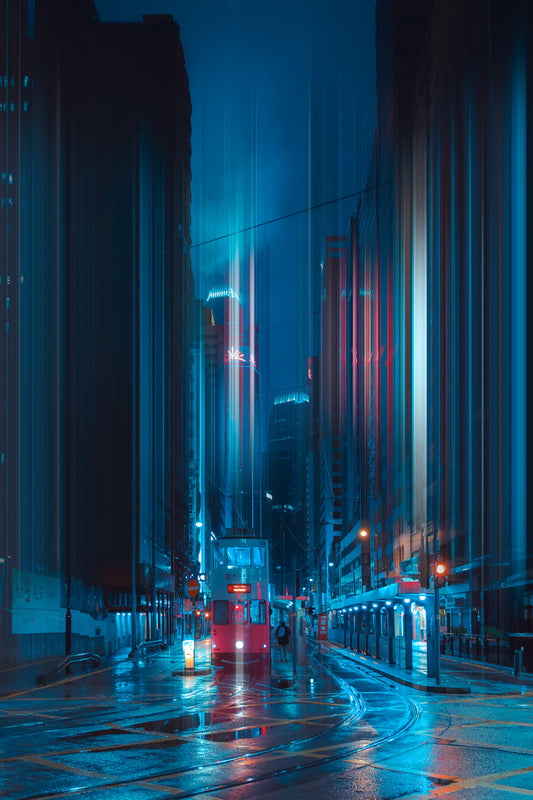A night urban scene with a street and buildings, the image is predominantly in blue tones with some red lights visible.
